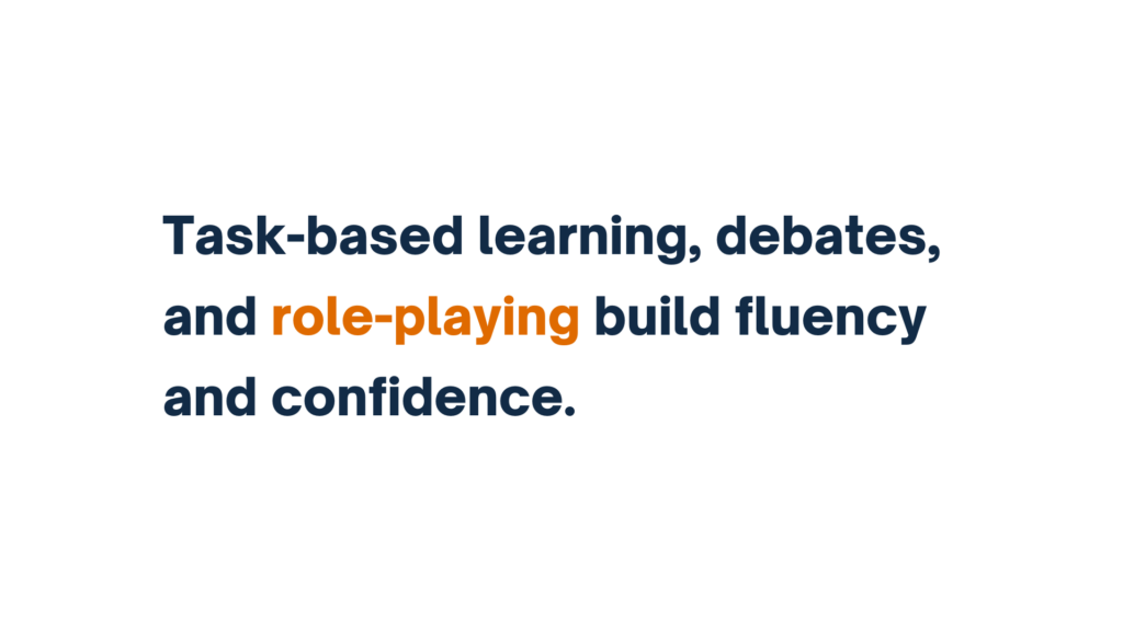 "Text image stating 'Task-based learning, debates, and role-playing build fluency and confidence,' with 'role-playing' highlighted in orange."